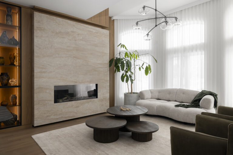 Living room beige stone wall fireplace – Germaine-Guèvremont Residence