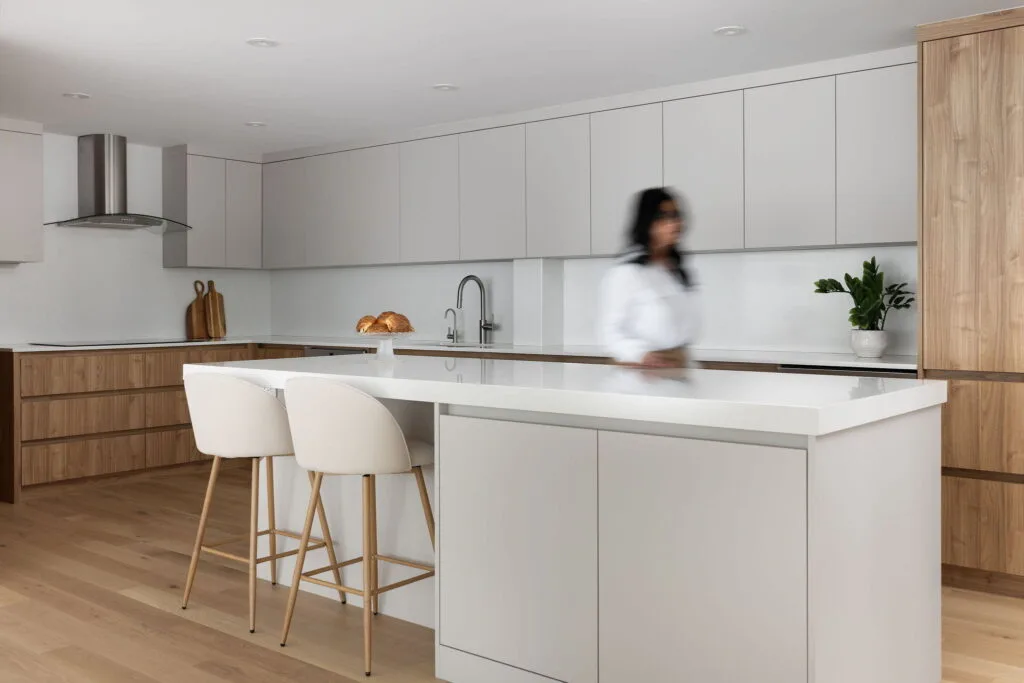 Renovated luxury condo dining area with sophisticated décor, warm color palette, designer lighting fixtures, and seamless integration with surrounding living spaces.