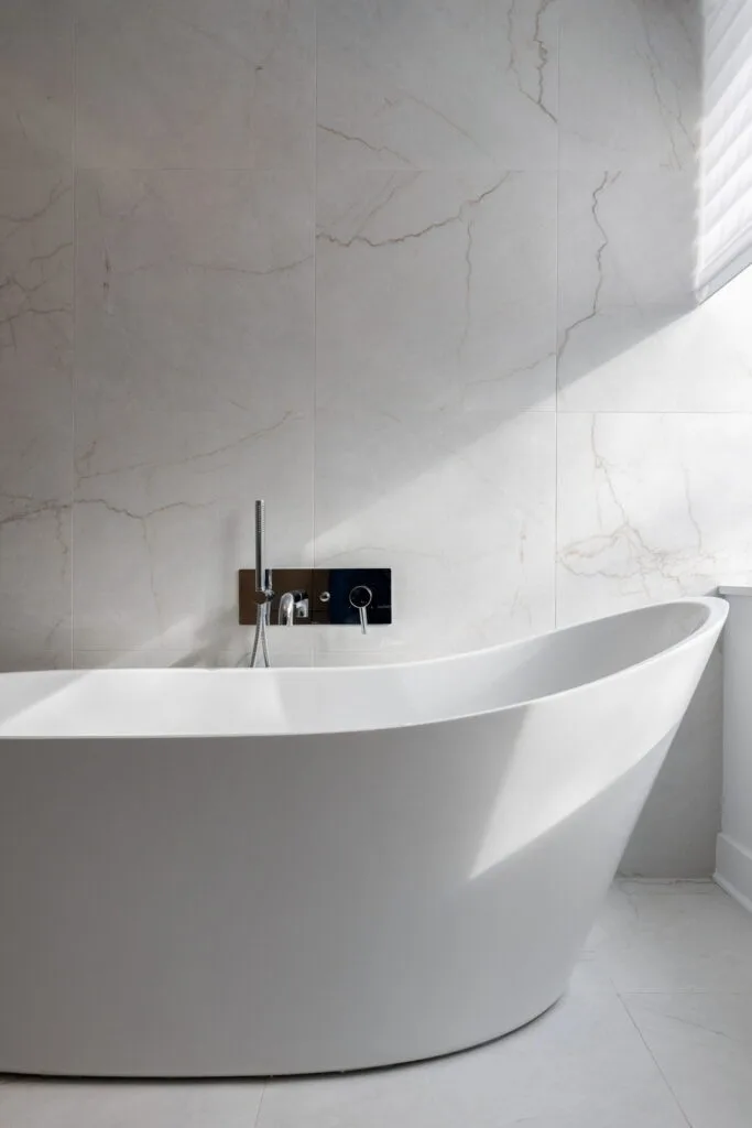 Contemporary luxury bathtub in a condominium bathroom featuring a freestanding design, high-end finishes, and a spa-like ambiance that emphasizes comfort and elegance.